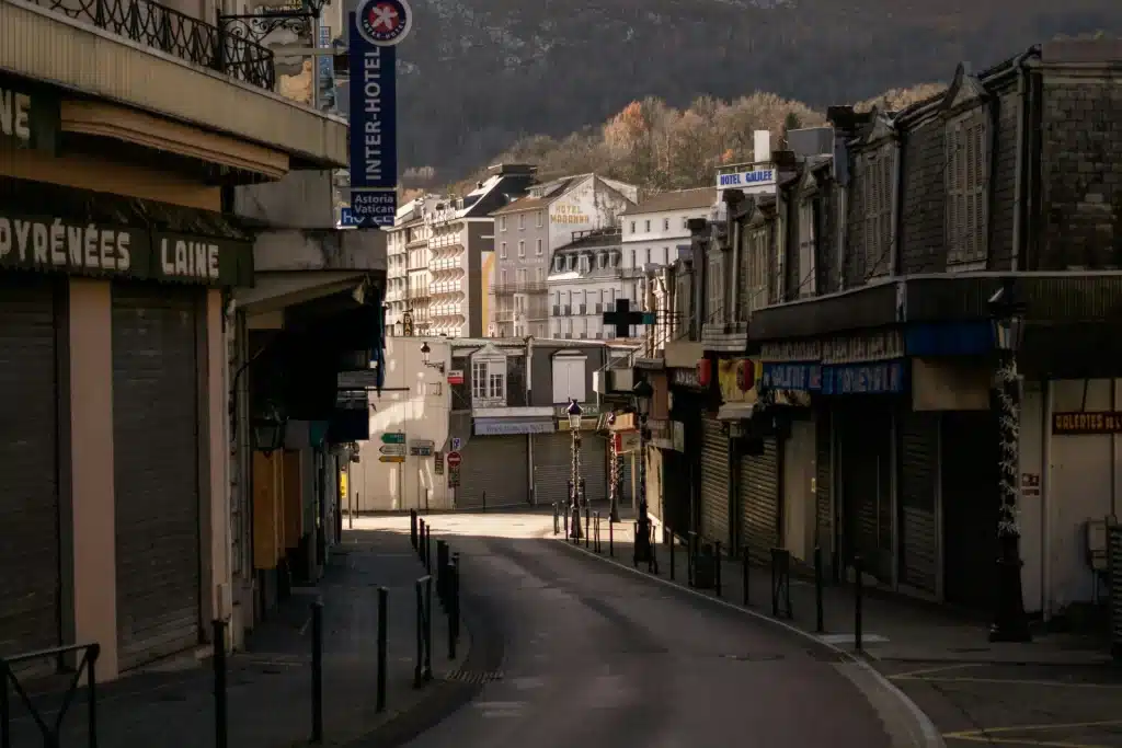 Quiet and empty street in Lourdes with views of local hotels.