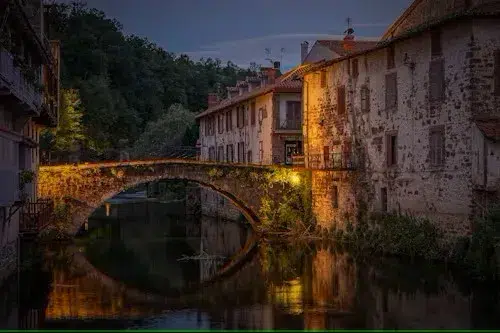 Historic bridge of Saint-Jean-Pied-de-Port illuminated at night on arrival from Biarritz