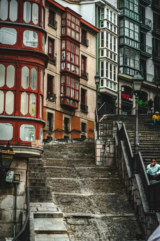 Historic street in the Casco Viejo district of Bilbao with colorful balconies.
