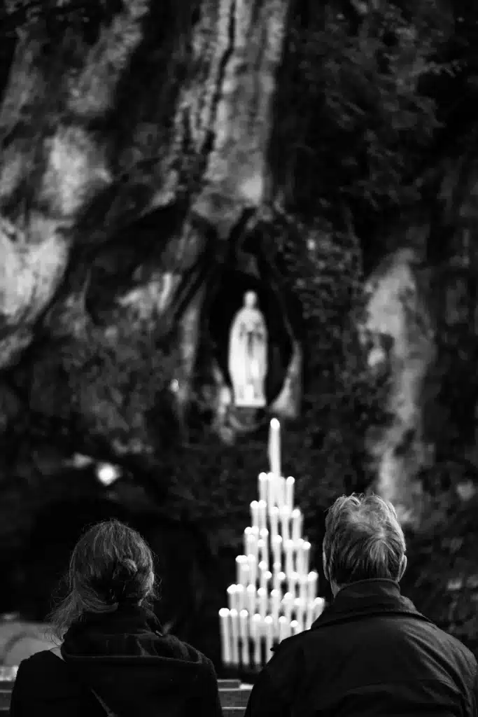Pilgrims in front of the Massabielle Grotto in Lourdes
