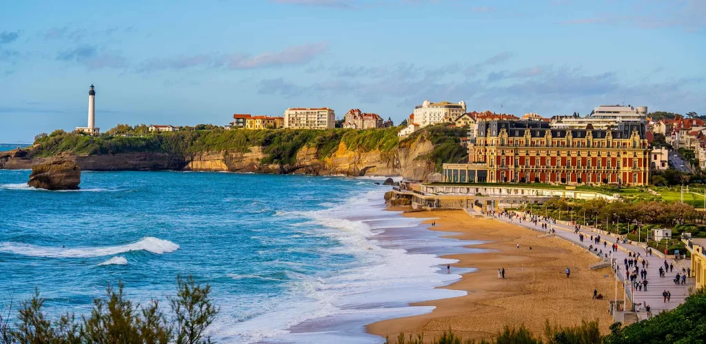 Panoramic view of Biarritz’s lighthouse, cliffs, and upscale hotels along the coastline