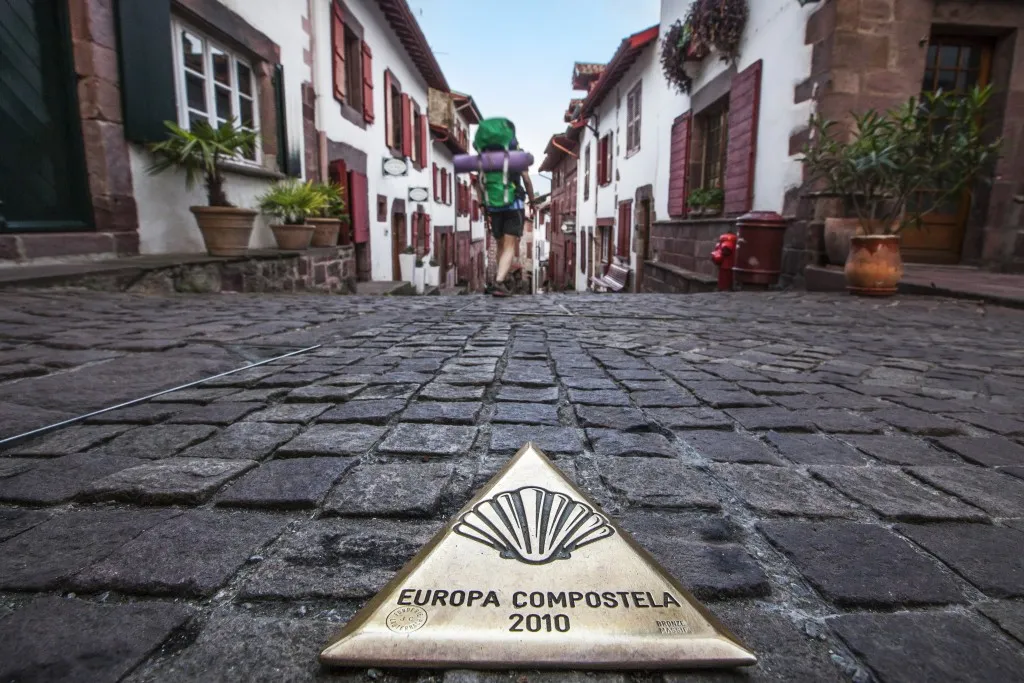 Pilgrim walking through Saint-Jean-Pied-de-Port on the Camino route