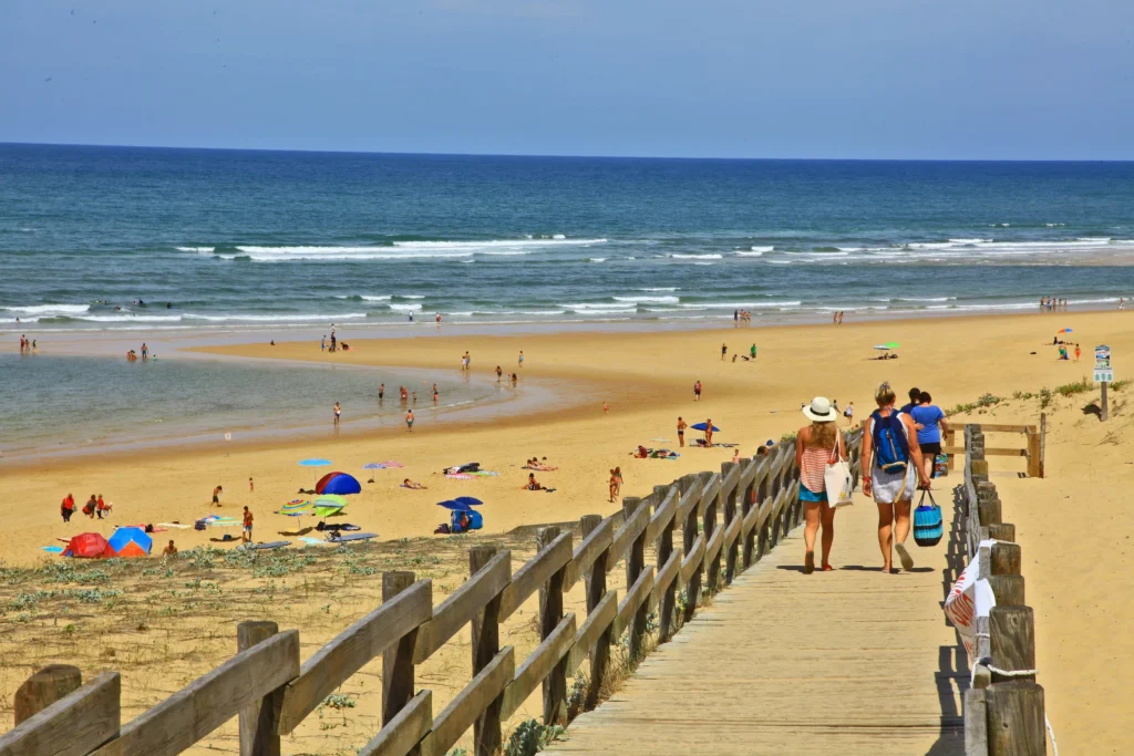 Families enjoying Moliets-et-Maa Atlantic beach boardwalk Landes – near Camping Les Cigales Biarritz airport transfer