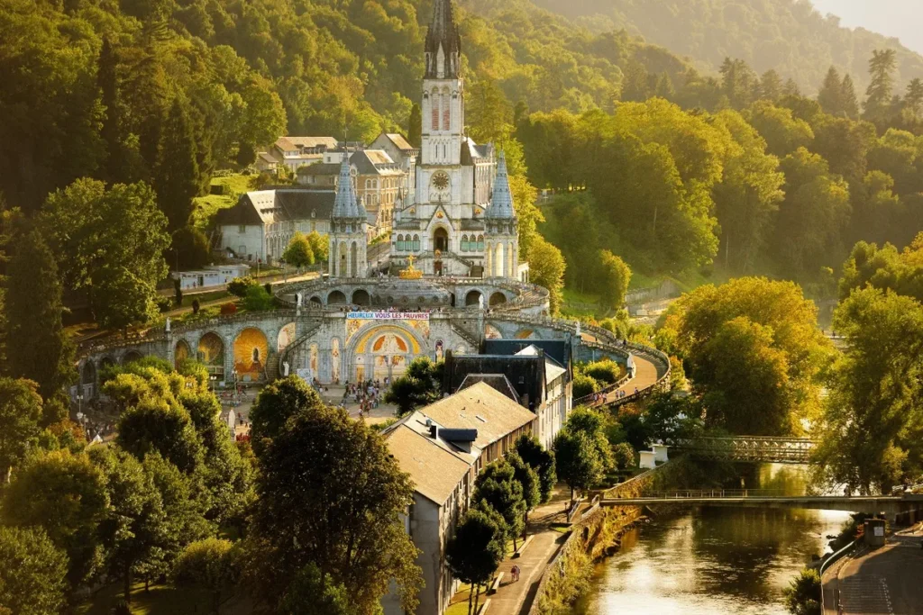 Biarritz to Lourdes taxi – basilica view from the Gave de Pau river and pedestrian bridge