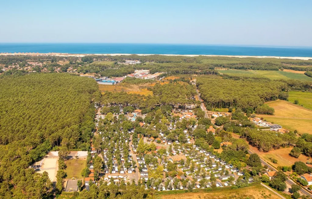 Aerial view of Camping Les Cigales Moliets-et-Maa with mobile homes pine trees and pools near Biarritz airport