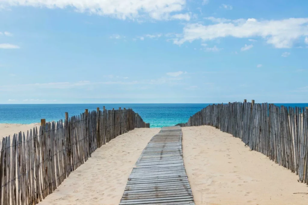 Wooden boardwalk beach access through sand dunes Landes coast near Camping Le Vieux Port Messanges
