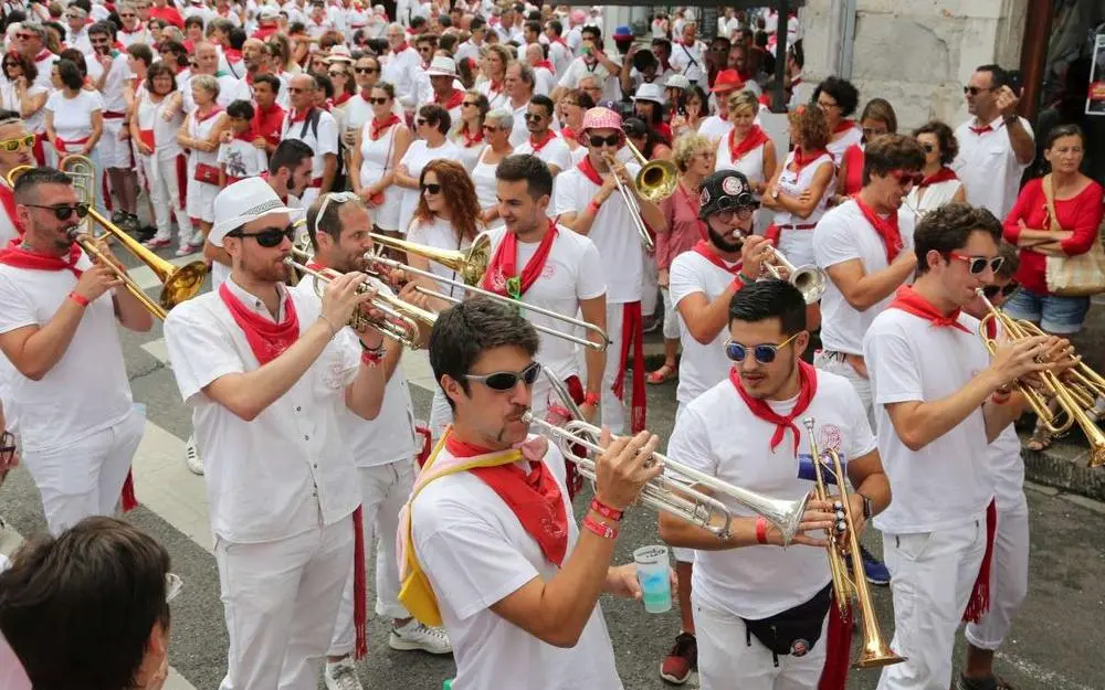 Bandas street musicians in white and red at Landes summer festival near Moliets-et-Maa